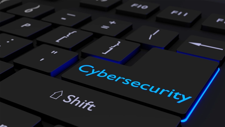 keyboard with cybersecurity key lit in blue