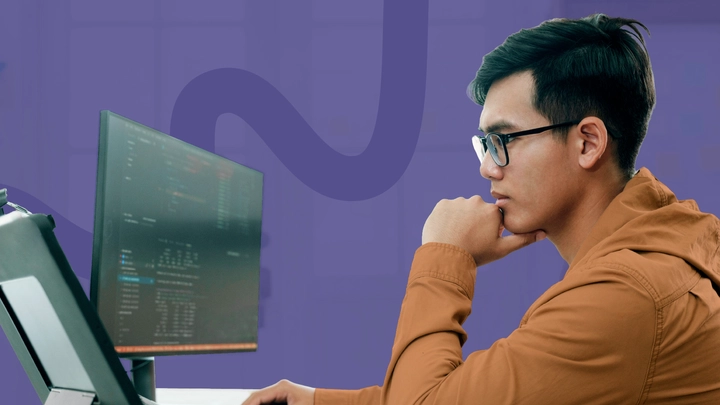 Cybersecurity analyst working on desktop computer