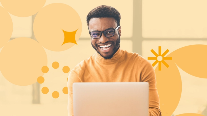 IT worker on laptop with floating graphics, representing getting a promotion in IT