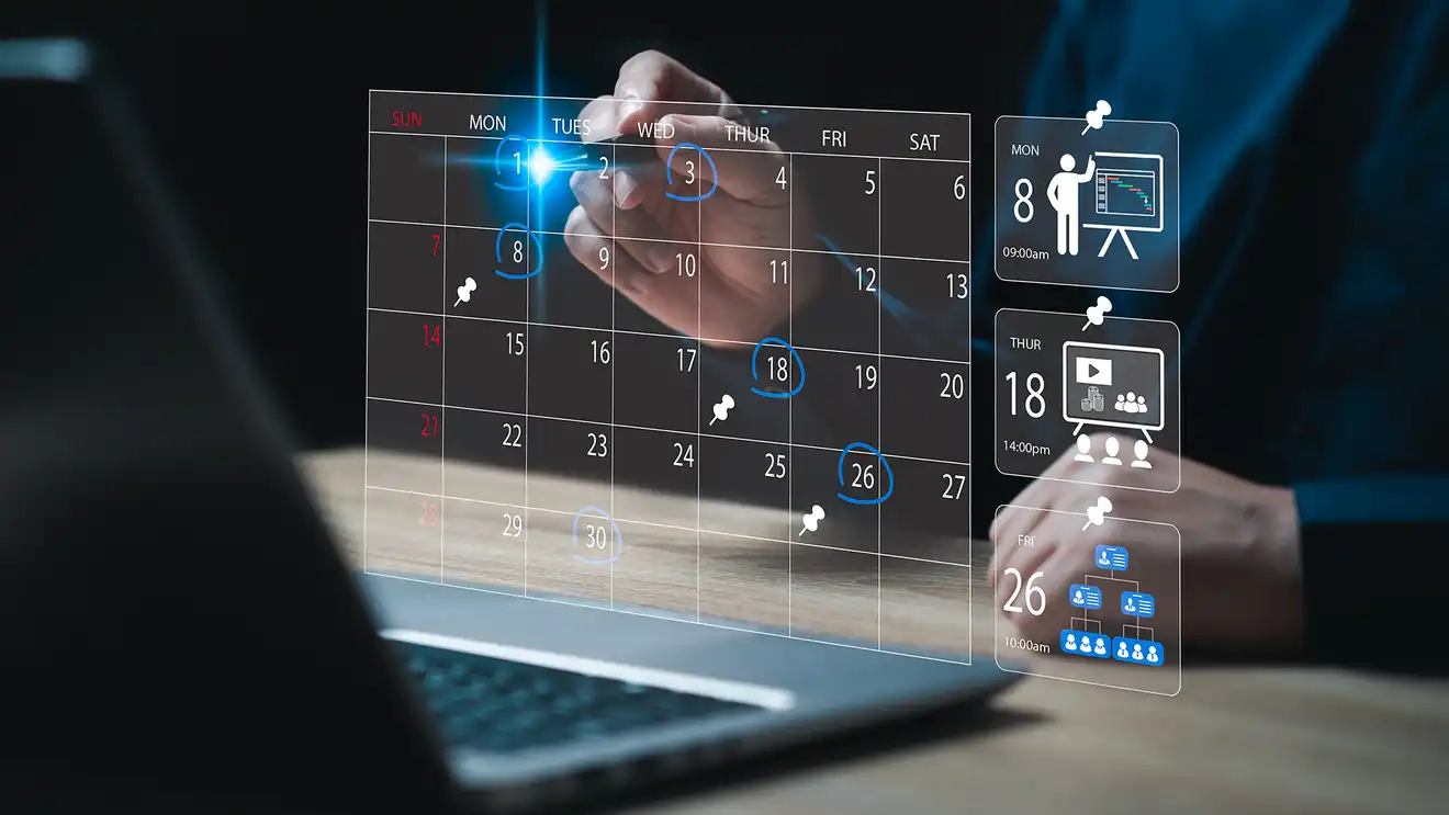 laptop open with calendar icons hovering above