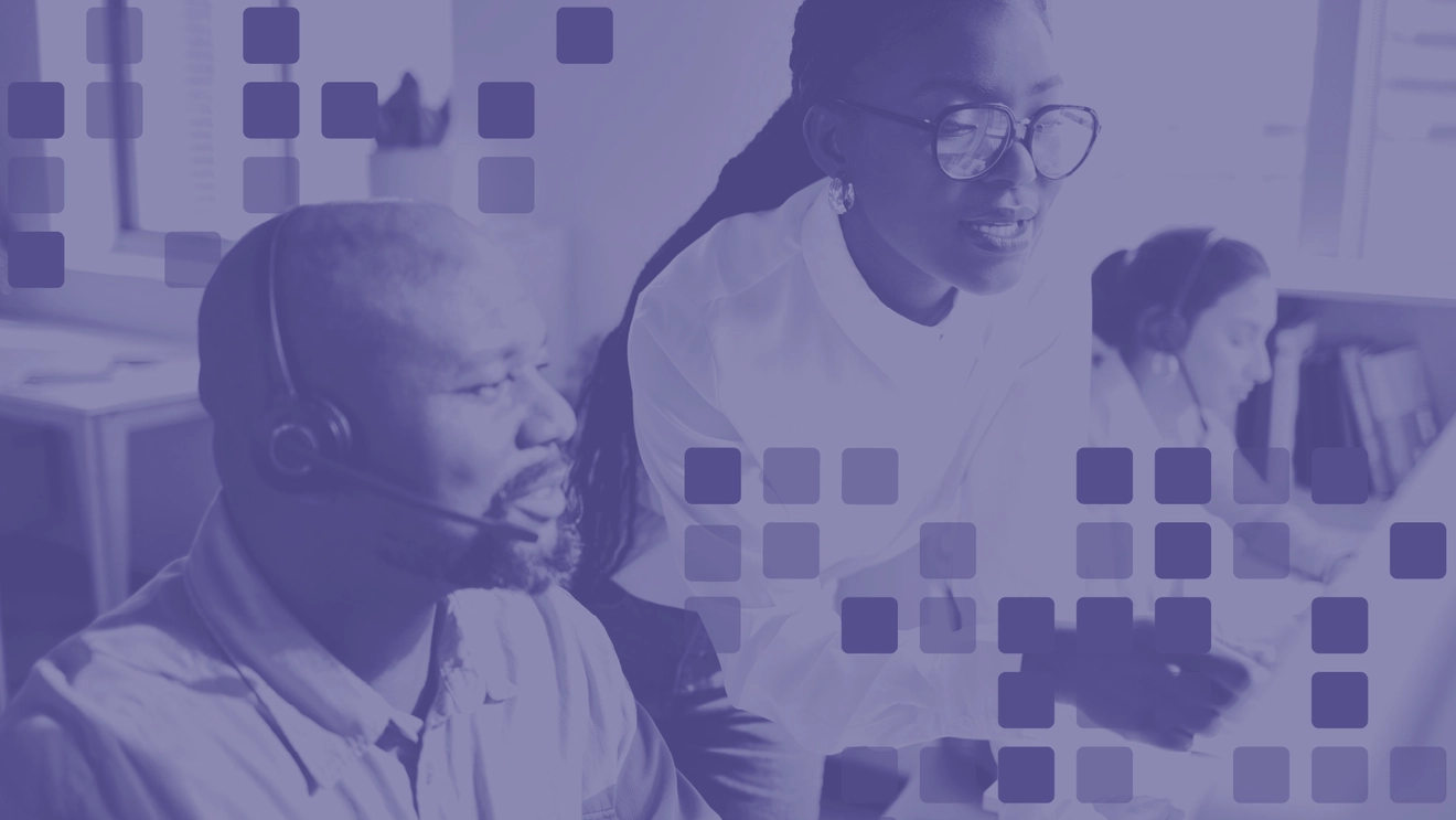 Computer support specialists assisting users in a technology support environment, representing IT jobs that can be pursued without a four-year degree.